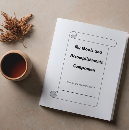 Goals and accomplishment companion journal beside a cup and a dried plant